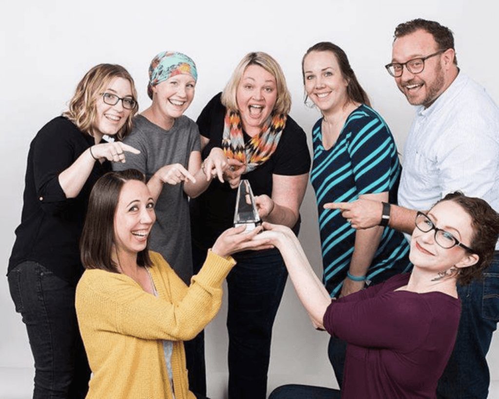 Lorilee and Shea and team winning award for her website design