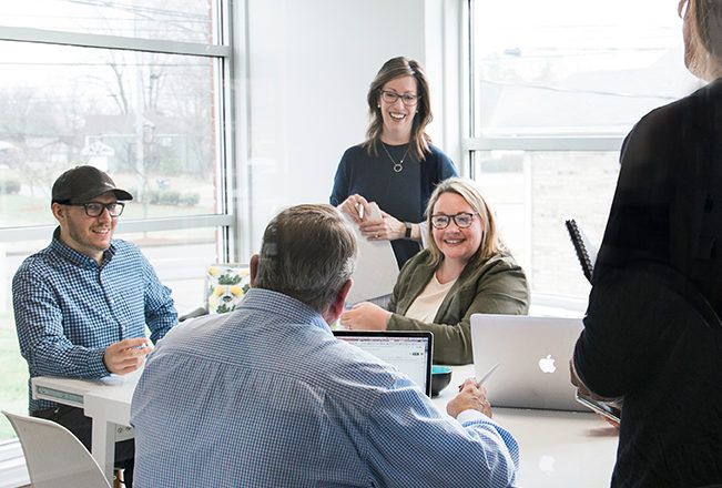 Thrive Creative Group Social Media Team Working In Conference Room